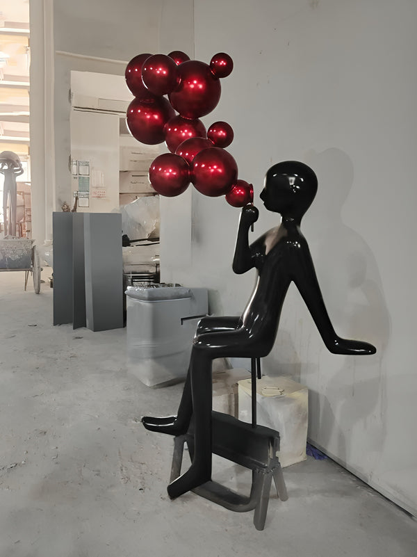 Abstract Character Sitting Blowing Bubbles Statue - Black / Cherry